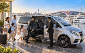 Family and business traveler entering a silver Mercedes V-Class with chauffeur in Abu Dhabi