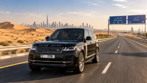 Range Rover chauffeur service between Dubai and Abu Dhabi with Arabian desert highway and skyline